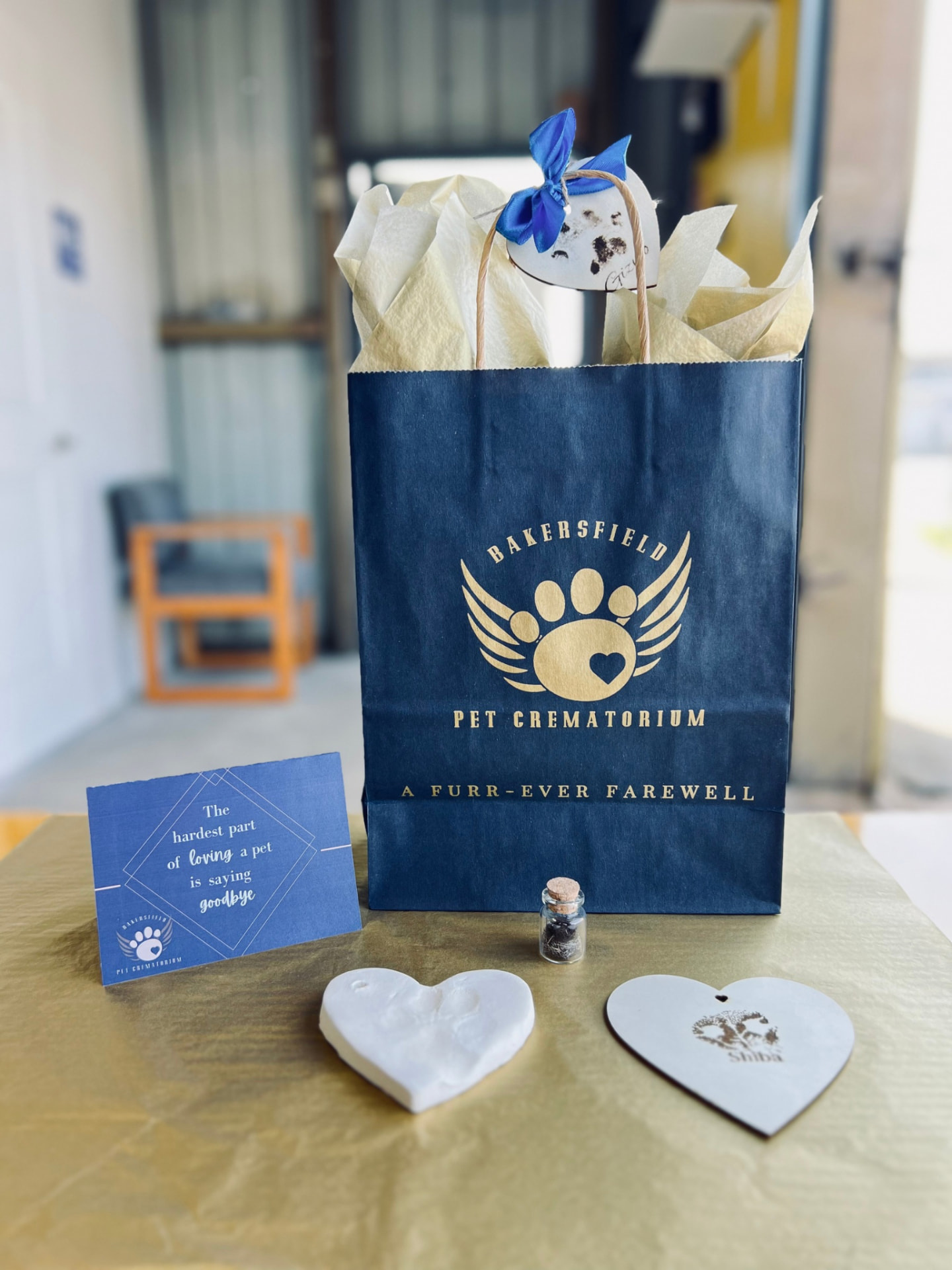 A handcrafted memorial keepsake collection included with every Bakersfield Pet Crematory cremation — wood keepsake, clay paw print, fur clipping vial, and farewell card.